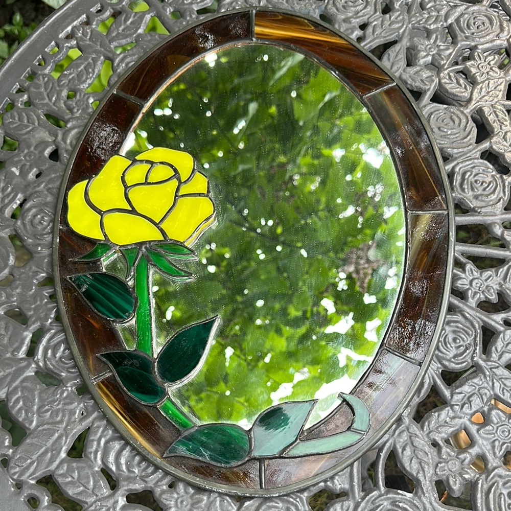 Oval stained glass mirror featuring a yellow rose
